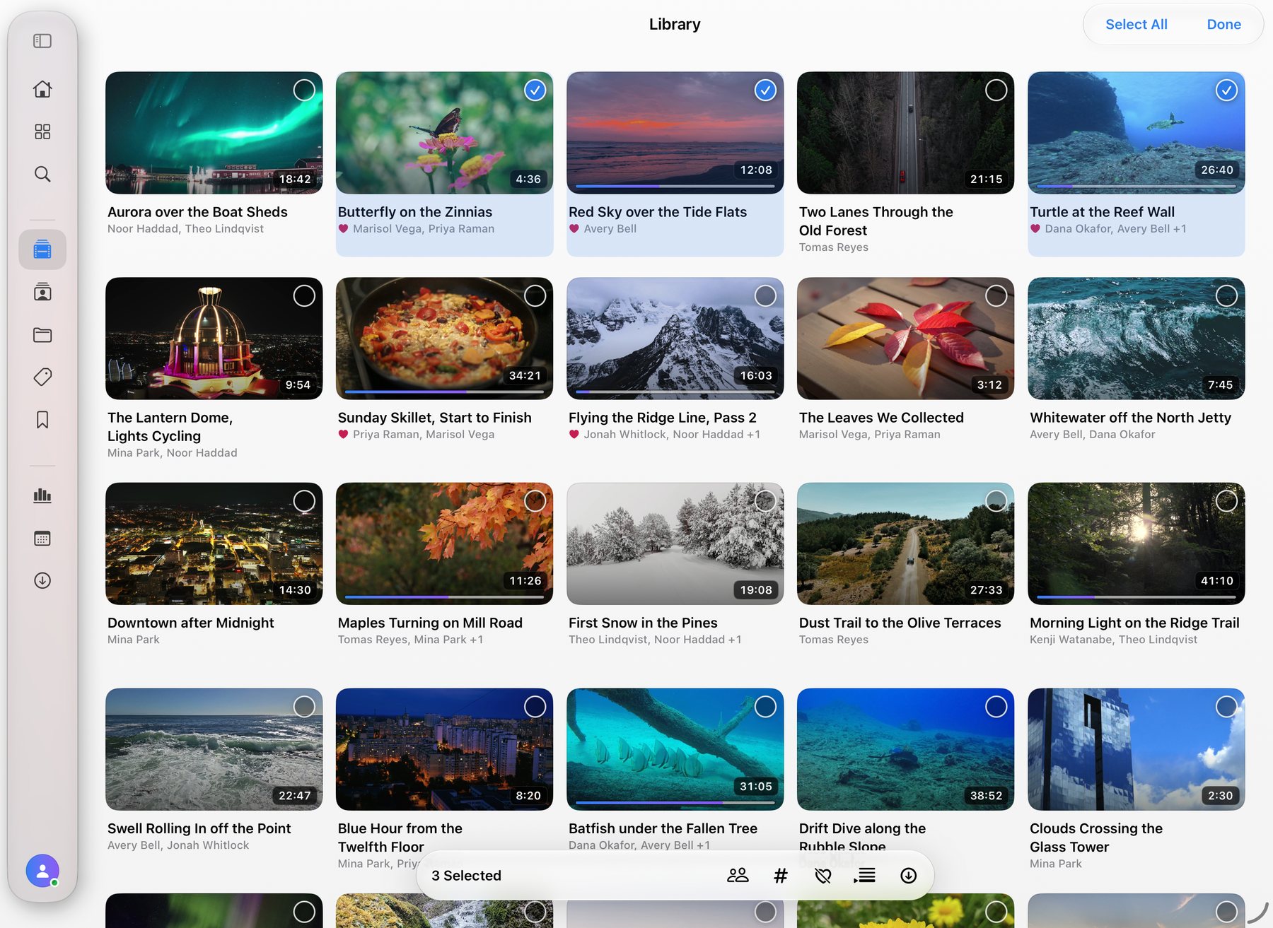 The library on iPad in Select mode: three videos chosen, with the organize bar along the bottom.